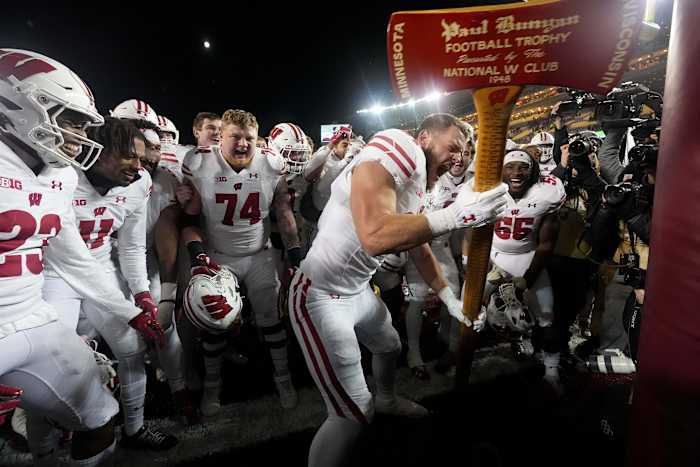 Nov 25, 2023; Minneapolis, Minnesota, USA; Wisconsin tight end Hayden Rucci (87) and teammates celebrate with the Paul Bunyan Football Trophy ceremonial axe to act out cutting down the goalposts after defeating the Minnesota Golden Gophers at Huntington Bank Stadium. Wisconsin won 28-14. Mandatory Credit: Mark Hoffman/Milwaukee Journal Sentinel via USA TODAY NETWORK
